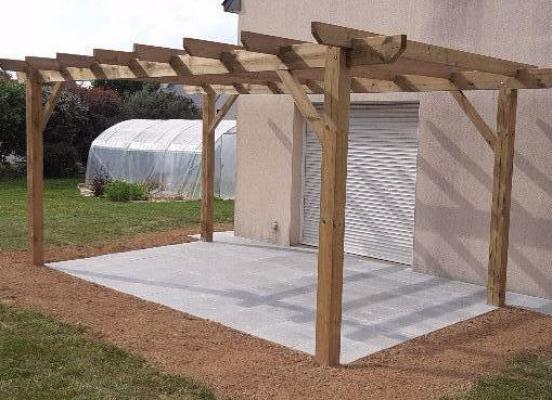 Terrasse et allées en pierre avec une pergola en bois à Tinténiac